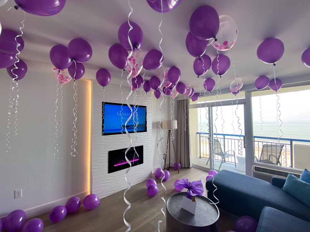 A ceiling of purple balloons in a Casanita suite
